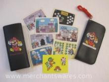 Nintendo Items including 2 Mario Eye Glass Cases and 6 The Adventures of Link Trading Cards, see