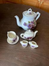 2 painted tea sets......Shipping