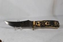 Imperial sheath knife with 5 inch blade. Leather sheath. Synthetic grips. Knife shows some rust and