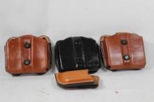 Four leather magazine belt holders.