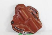 One brown leather De Santis right handed belt revolver holster, 002 61. Used in good condition.