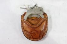 One set of S&W handcuffs with key in tooled leather belt case. Used.