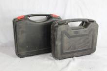Two black plastic pistol boxes. Used.