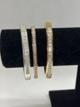 Two Gold Tone Rhinestone Bracelets, and One Silver Tone Rhinestone Bracelet