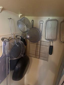 contents of kitchen pantry frying strainers, plasticware, ironing board and more
