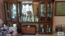 Large curio cabinet with glass on all sides. It is lighted and has an open shelf in the very center