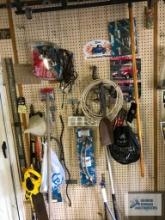 LEVEL, TAPE MEASURE AND OTHER TOOLS ON WALL