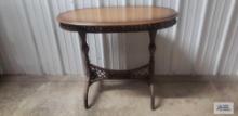 Wood oval table with wicker base. 29 in. tall by 36 in. long by 18 in. wide