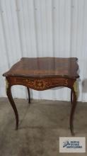 Antique table with floral design. 29 in. tall by 30 in. long by 24-1/2 in. deep