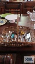 Basket with assorted flatware, corn holders, Hors d'oeuvres servers and child's flatware