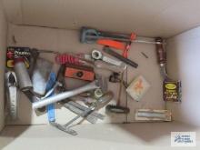 Assorted tools including chisels, utility knives, carpet knife, sanding block, pouring spout