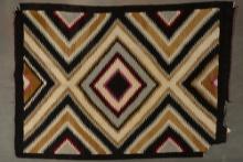 Large Navajo Eye Dazzler Rug, measures 45" W x 60" L. Rug has damage to one corner and some damage o