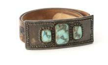 Turquoise and silver oblong Buckle, 6" L x 4 1/4" T, accompanied by a western tooled Belt with wagon