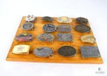 Sixteen Firearms Related Belt Buckles on a Wooden Display Board