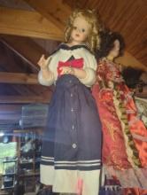 (GAR) Blonde Haired and Blue Eyed Porcelain Doll Wearing a Blue and White Sailors Dress with Red Bow