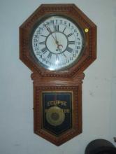 (SBD) New Haven Eclipse regulator clock with an oak case. 18" W x 3.5" D x 33" H. Sold Where Is