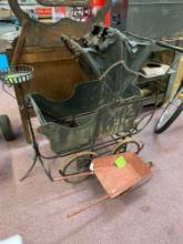 Vintage baby buggy top is in rough shape, vintage child?s wheelbarrow metal and a plant stand