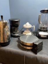 Miscellaneous kitchen appliances including a KitchenAid blender, juicer, waffle iron 2 coffee pots