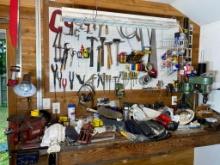 Contents of tool bench top and wall including large Vice, drill press