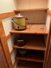 Closet with slow cooker and kitchen items