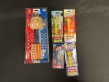 Larger PEZ Machine and 4 Smaller PEZ Machines still in the packaging