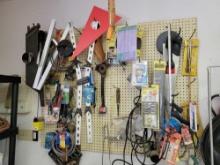Contents of pegboard, saws, guides, wrenches, hardware