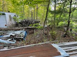 Large piles of rough sawn lumber and tin all one money