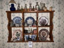 wall shelf with contents antique plates , glassware