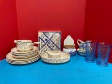 Partial temperware dishes, royal Copenhagen candles and napkins, blue Delft, and two cubist glasses